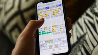 Quordle on a smartphone held in a hand
